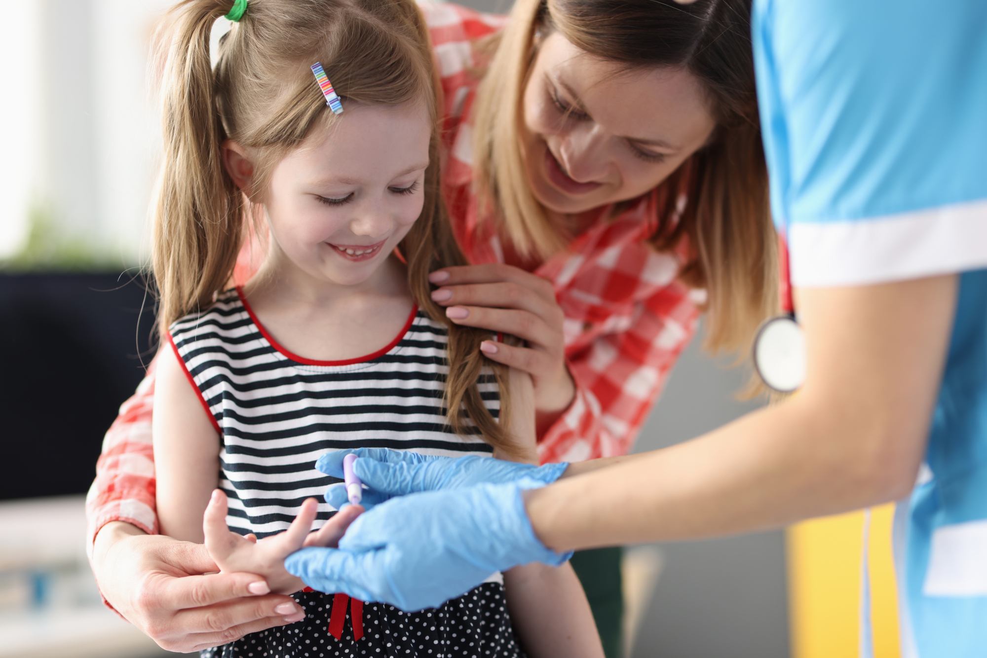 A young girl takes a finger test for diabetes monitoring.