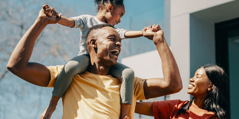 A family laughs and plays together.