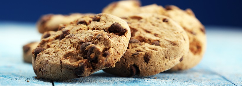 Chocolate chip cookies stacked on top of each other against a blue background