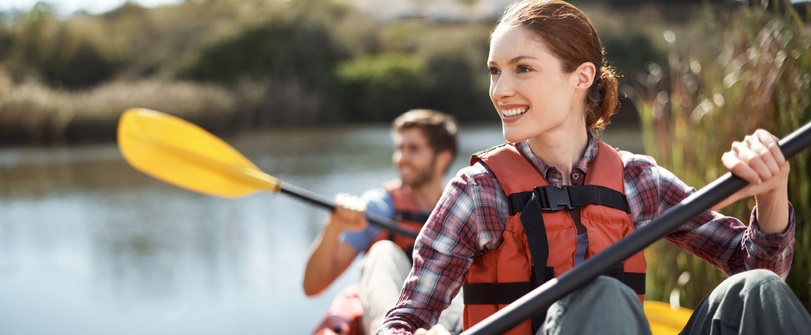 Couple kayaks on a lake together.