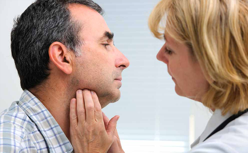 A doctor examines a patient's neck.