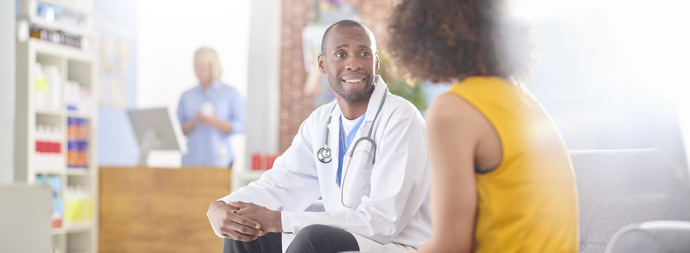 A doctor talks to his female patient.