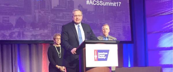 Dr. Timothy Mullett speaks at a lectern.