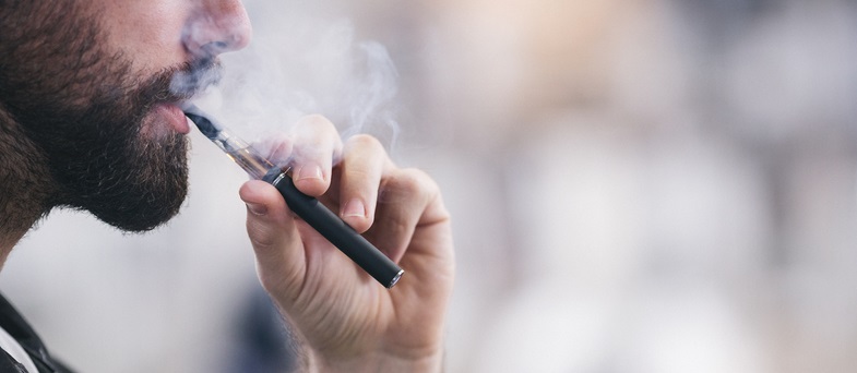 Man smokes an e-cigarette.