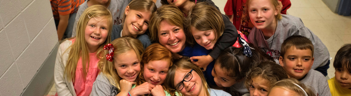 Erika Carter is surrounded by her students.