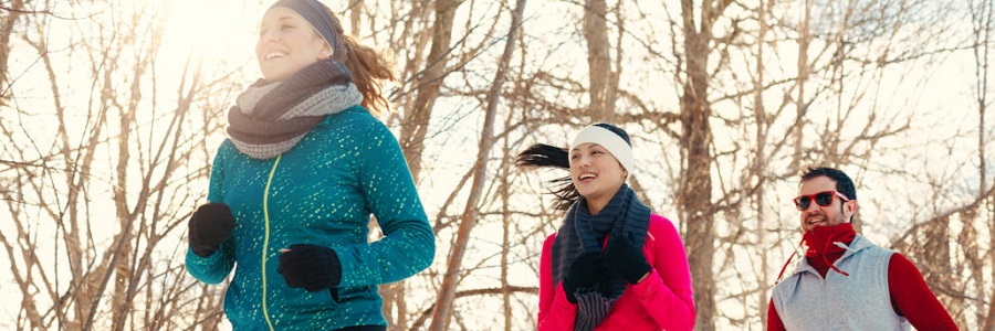 Three people running in the cold.