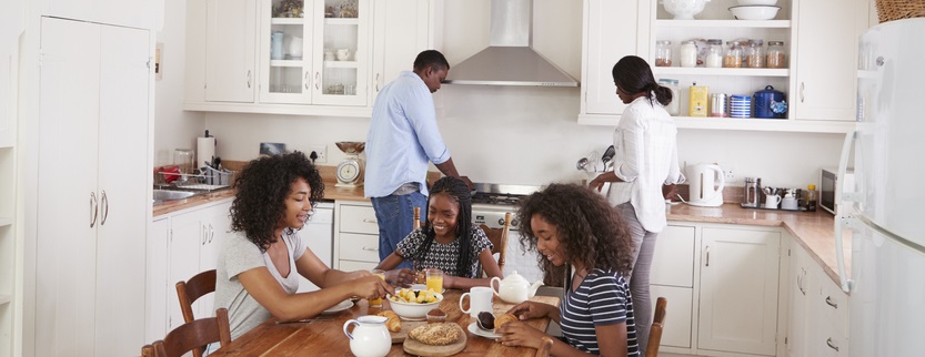 Family eats breakfast together.