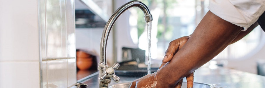 Washing hands in a sink.