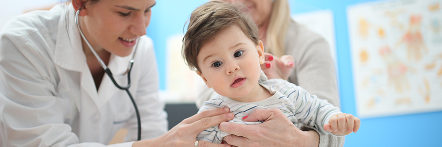 Female doctor with stethoscope listening to the baby patient