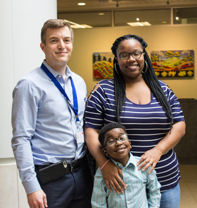 Daniel “DJ” Johnson and his mother, Keisha, with Dr. Brandon Miller.