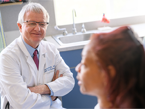 Dr. David Booth talks with a patient.