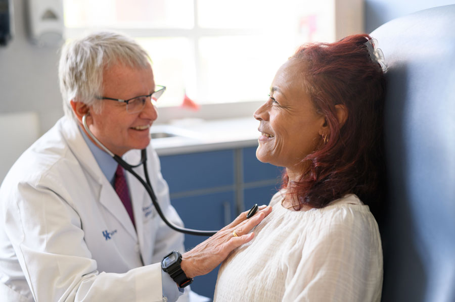 Dr. David Booth listens to Nichole Creech's heart.