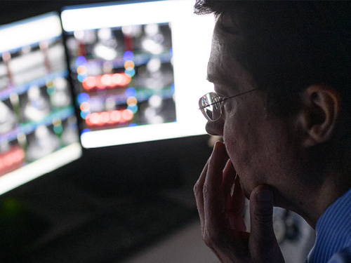 Dr. John Gurley looks at heart images on computer monitors.