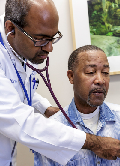 Dr. Navin Rajagopalan listens to Joe Madison's heart.