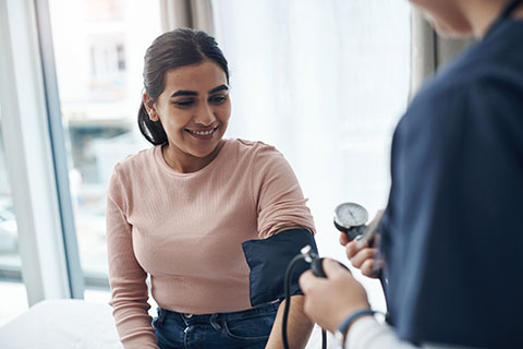 A female patient has her blood pressure taken.