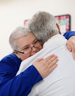 Kelly Kampmann hugs Dr. Tom McLarney