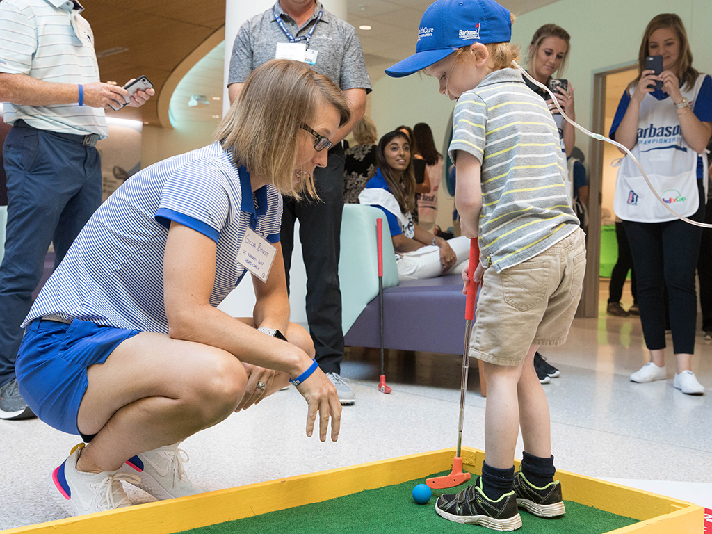 A young patient golfs.