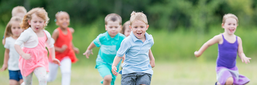 Group of young kids running outside