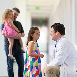 Doctor speaks with child.