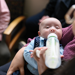 mother feeding baby bottle