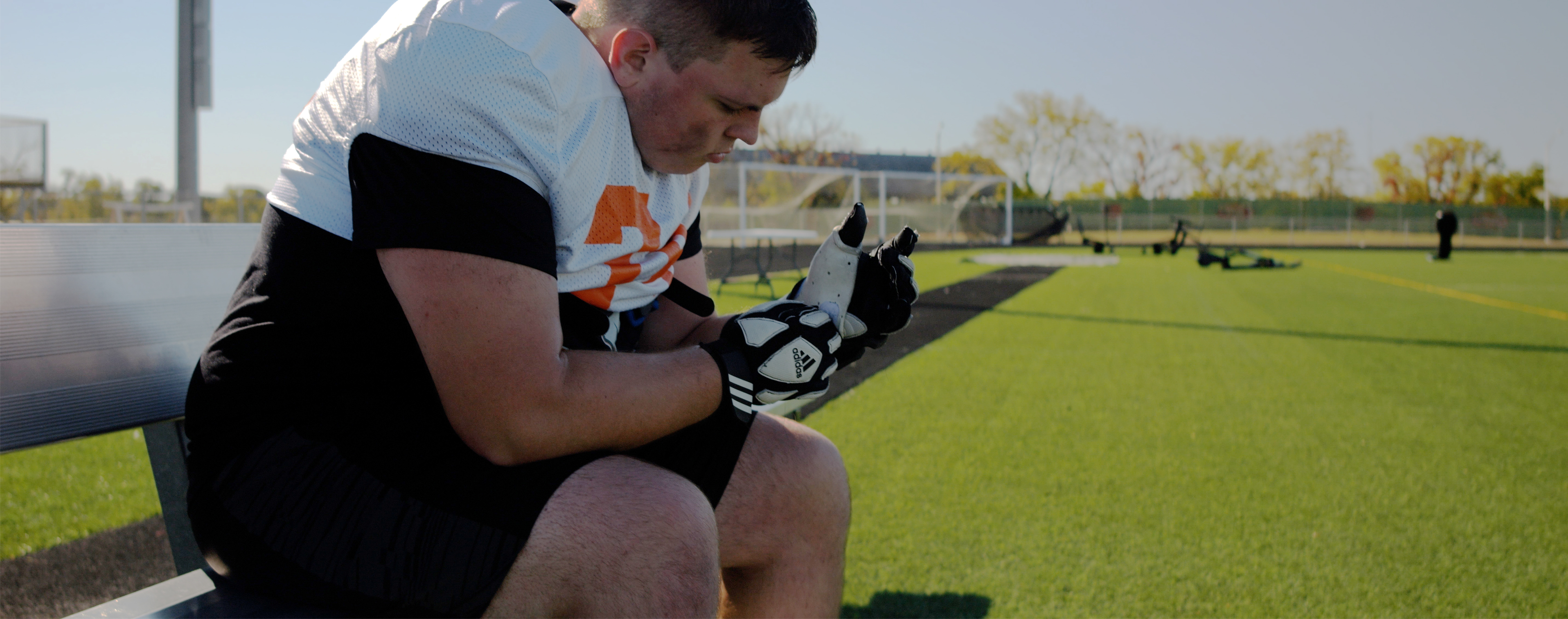 Frederick Douglass football player Walker Johnson examines his hand.