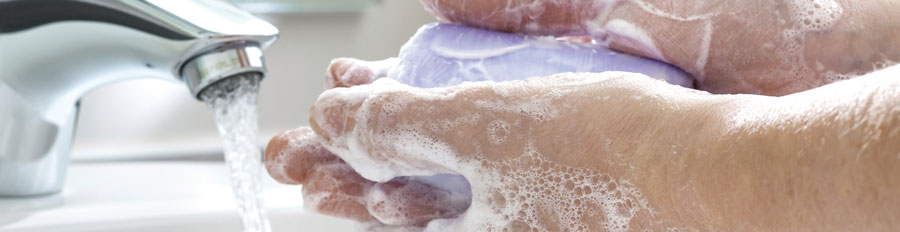 Washing hands under a faucet.