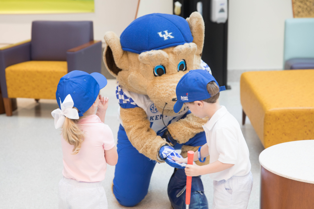 Mascot Scratch gives a patient "five."