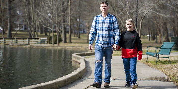 Justin Clark walks with his son.