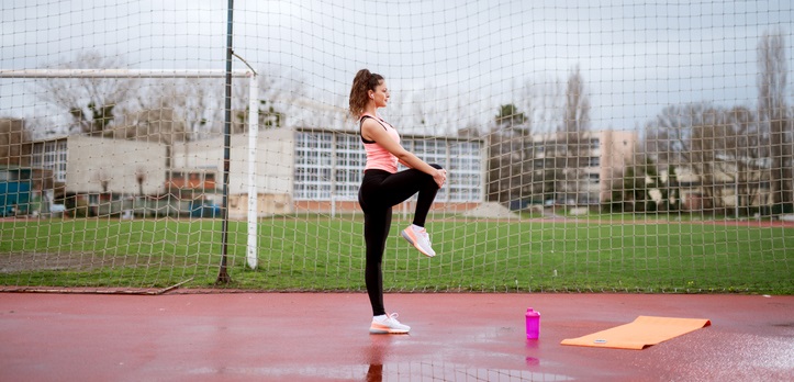 Woman stretches her knee.