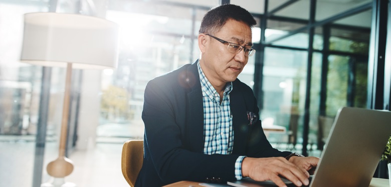 Man researches on his laptop.