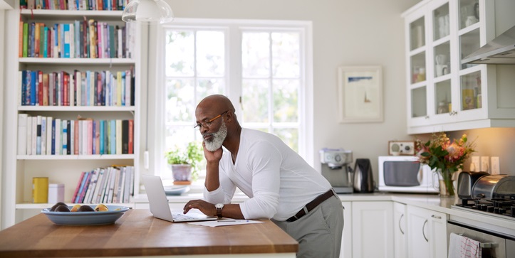 Man reads on his computer.