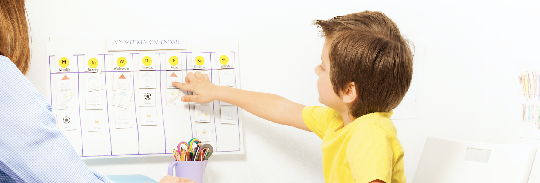 Mother and son creating their weekly schedule.