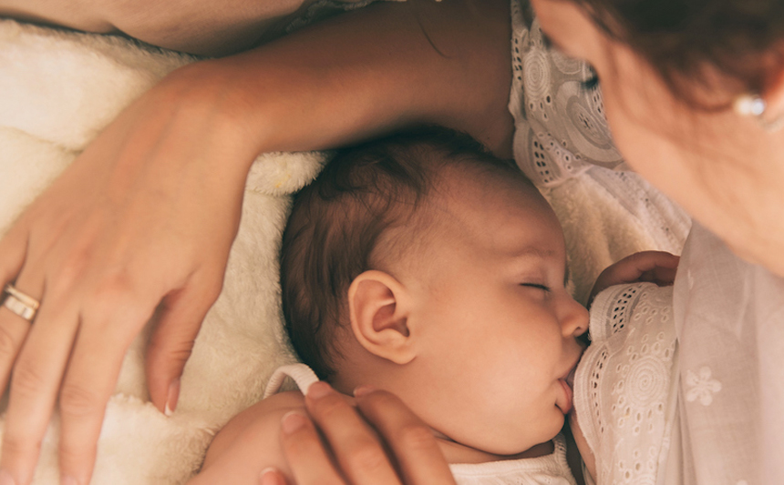 Baby latching on to mother's breast.