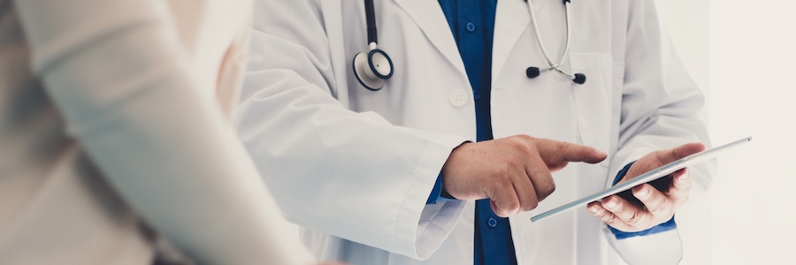 Doctor sharing image with patient on a tablet device.