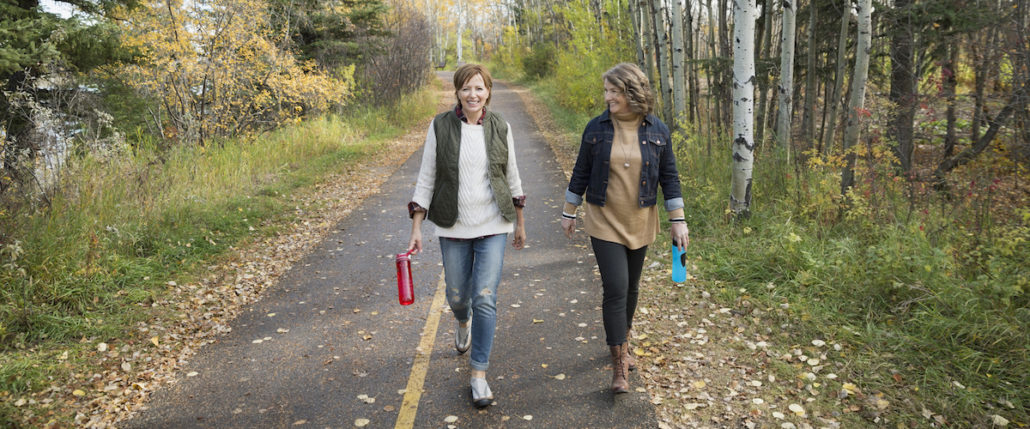 Women walking along a road outdoors