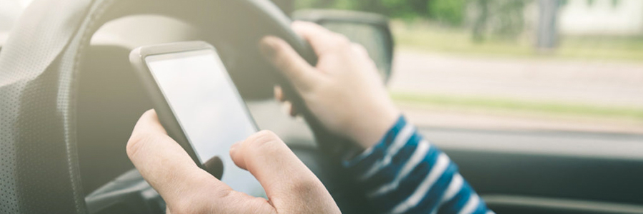 A driver texts using a cellphone.