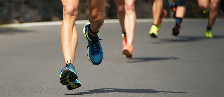 Several people running, only visible knees downward.