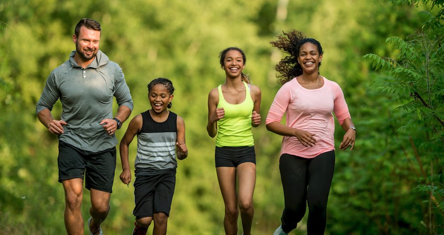 A family jogging together outside.