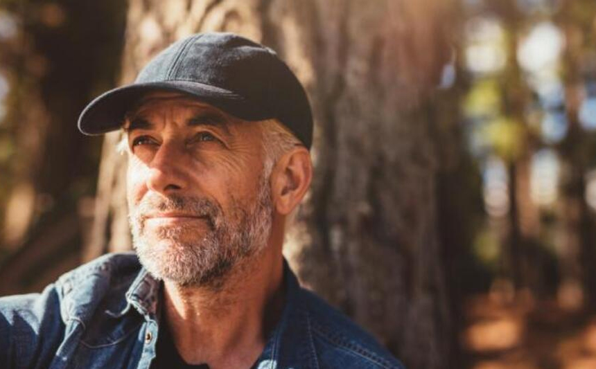 A senior man wearing a ballcap.