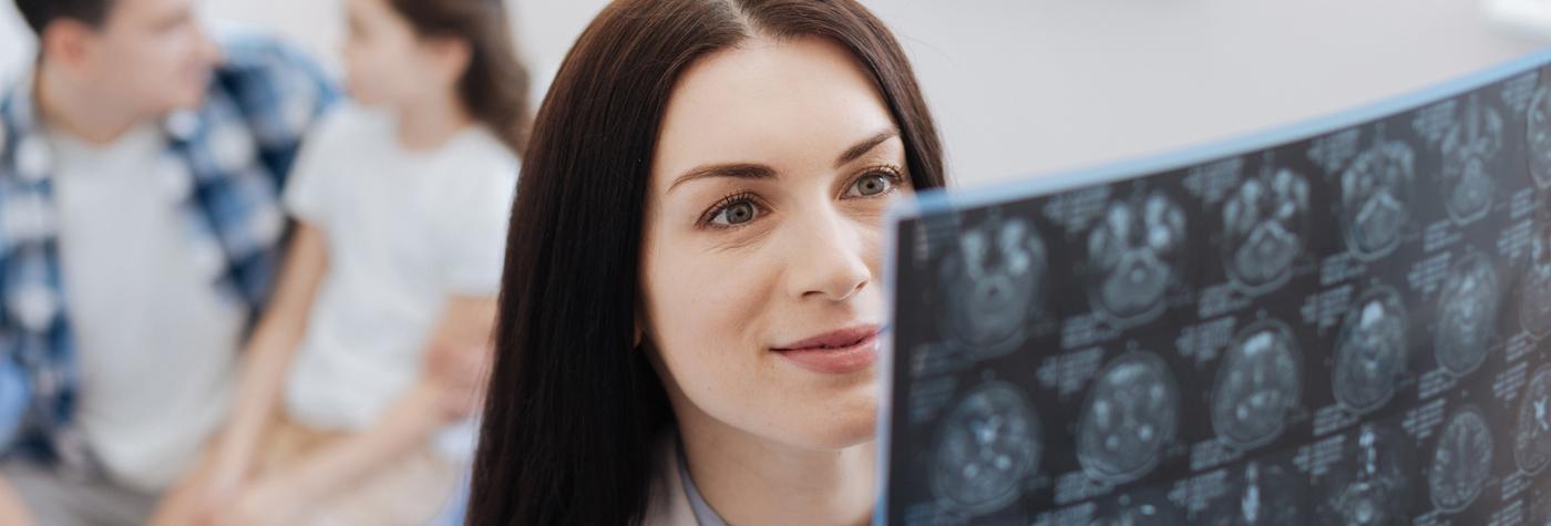 Provider examining medical image scan.