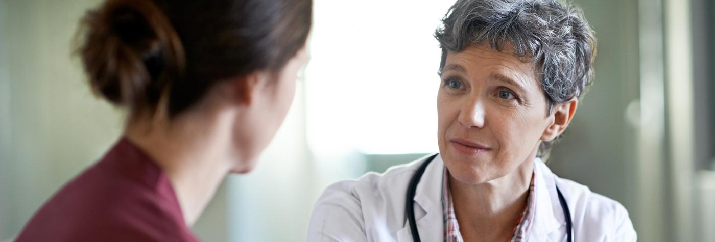 A female provider and patient have a discussion with one another. 