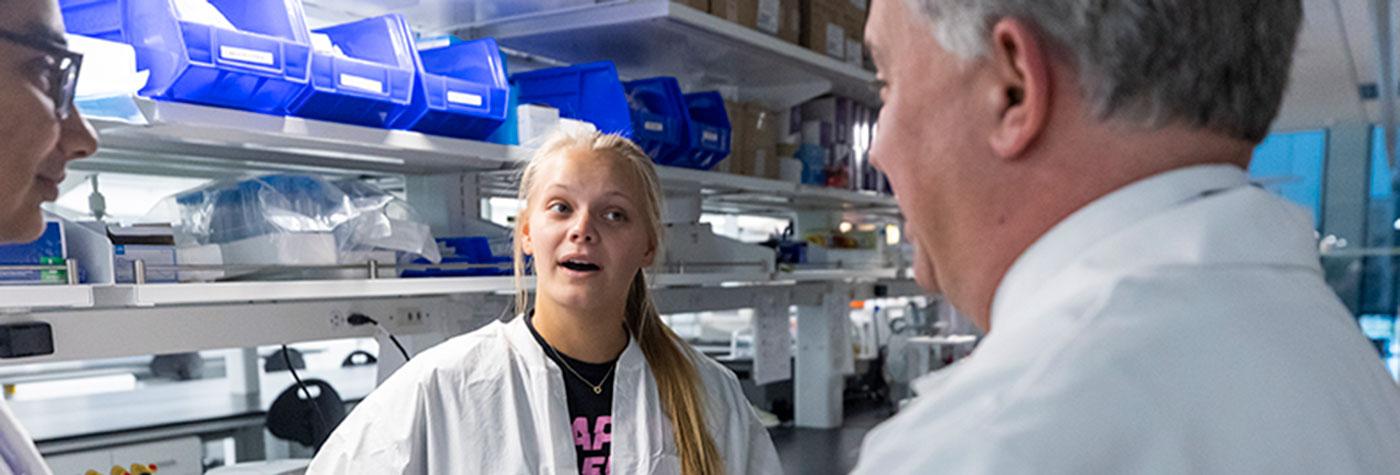 Members of a BBDC research team have a conversation in the lab. 