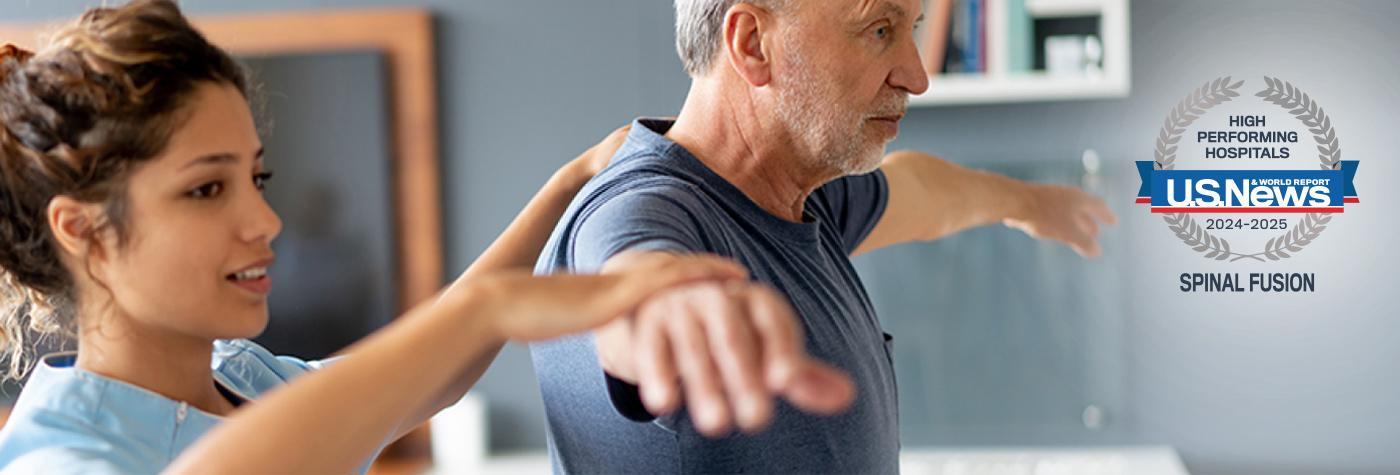 A provider examines a patient's back.