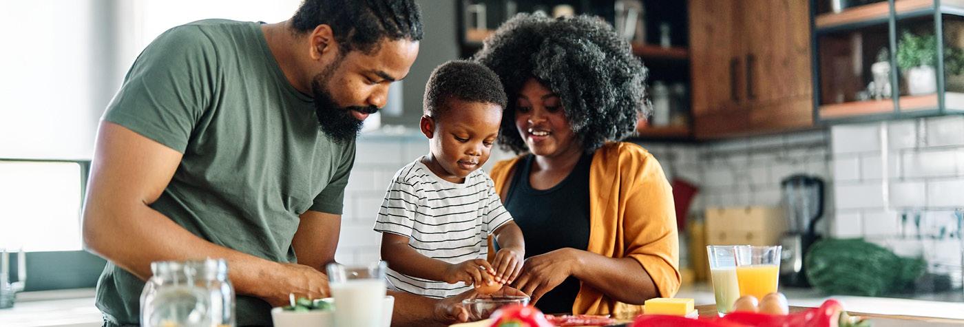 Family members preparing food in home kitchen - nutrition