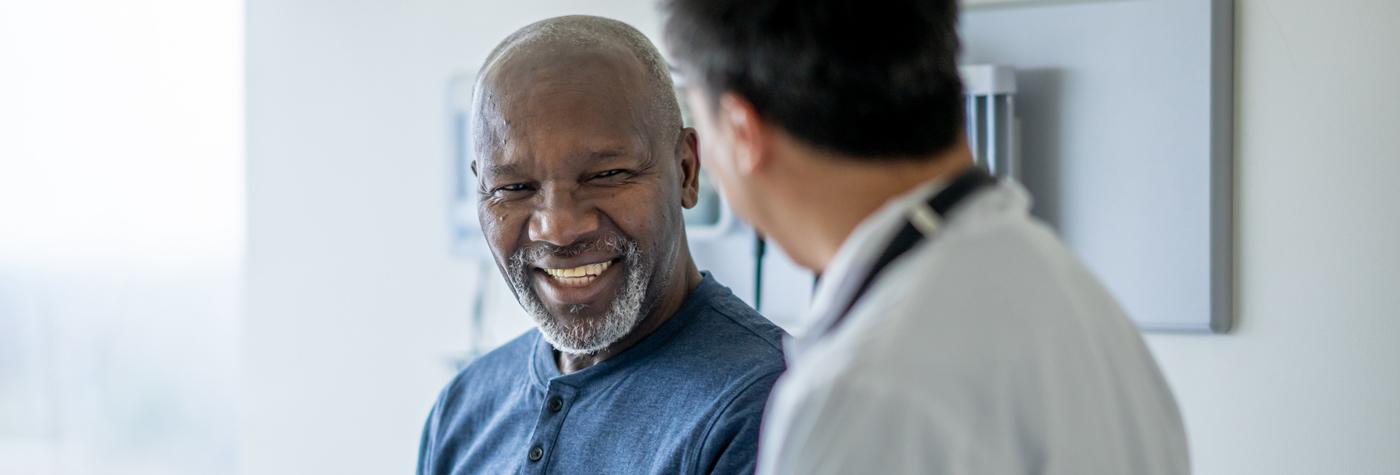 man discussing treatment with physician