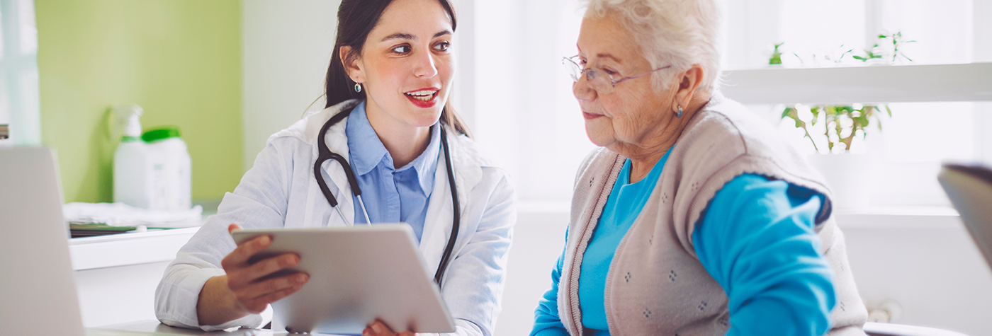 doctor smiling as she consults with patient