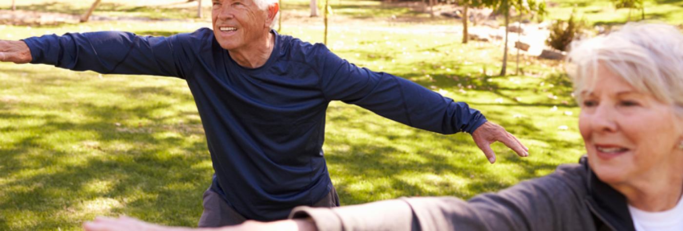 Man and woman practicing tai chi outdoors