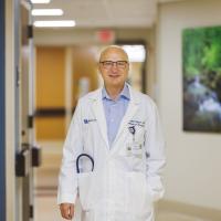 Dr. Ralph Zinner standing in the hallway of a clinic.