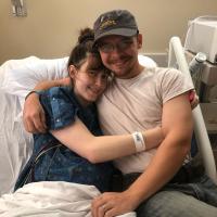 Sarah and Dave Custer hug before an operation to place a stent.