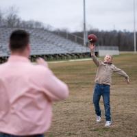 William Dean throwing a football to his father Tyler Dean